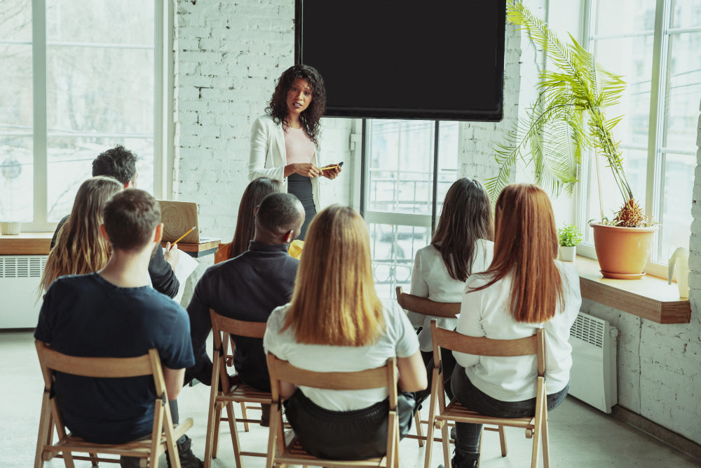 female african american speaker giving presentation hall university workshop